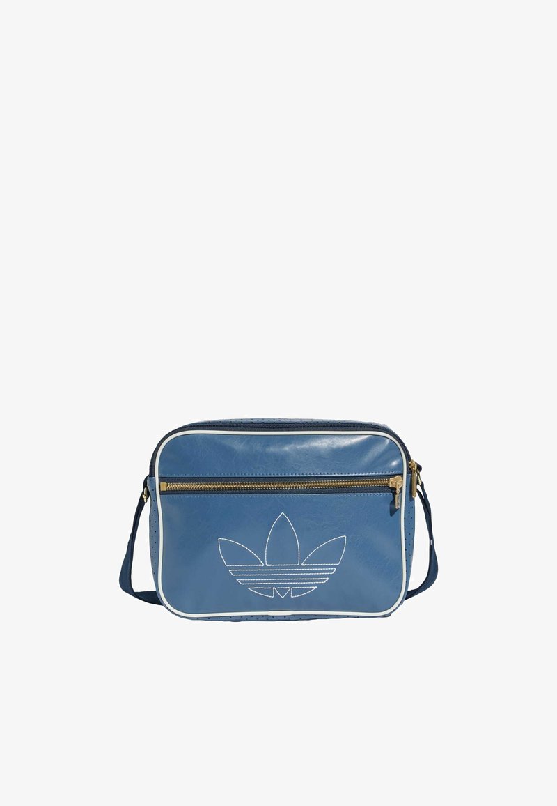 Sac à main en simili cuir bleu avec des détails blancs, poche zippée à l'avant et logo brodé. Forme rectangulaire avec une bandoulière réglable.