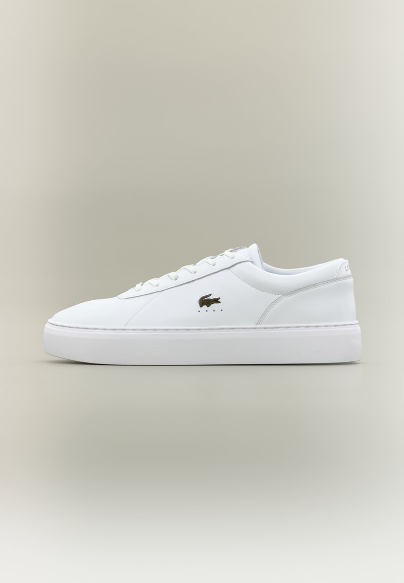 White leather sneakers with a smooth texture, featuring a low-top design, lace-up front, and a small crocodile logo in dark brown.