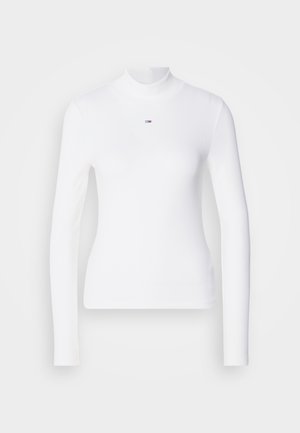 Witte turtleneck met lange mouwen, gemaakt van ribbelmateriaal, met een klein logo op de borst.