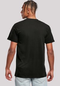 Black cotton t-shirt with a crew neckline and short sleeves. Features a relaxed fit and smooth texture. Simple design, no visible graphics.