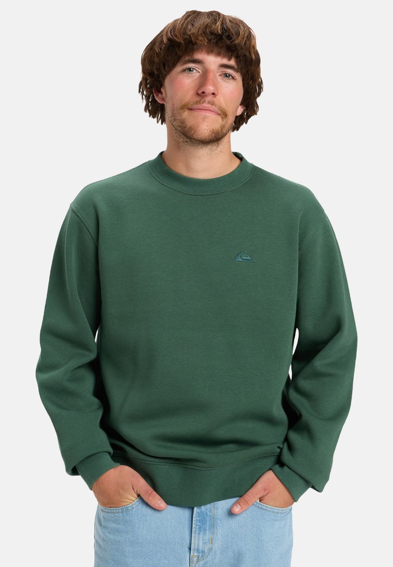 Green sweatshirt in a soft material, featuring a round neckline and ribbed cuffs. Small logo detail on the chest. Casual fit.