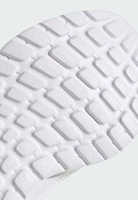 Semelle blanche de chaussure avec motif de traction rectangulaire en relief et surface texturée pour l'adhérence et la durabilité.