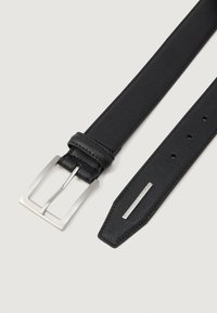 Musternäitega must nahkrihm, millel on hõbedane ristkülikukujuline pandla ja metalline Armani Exchange'i logo silt terava otsa peal.