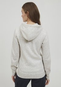 Hellgrauer Kapuzenpullover aus weicher Stoffqualität. Verfügt über einen lässigen Schnitt, gerippte Bündchen und eine klassische Kängurutasche.