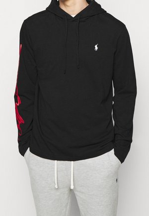 Black long-sleeve hoodie made of cotton, featuring a small white logo on the chest and red graphic design on the left sleeve.