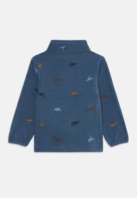 Pullover in pile blu con finitura testurizzata, caratterizzato da motivi colorati di dinosauri in arancione, marrone e azzurro chiaro sulla schiena.