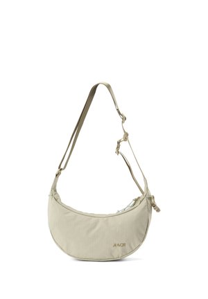 Light beige crescent-shaped shoulder bag with adjustable strap and small logo on the front right side.