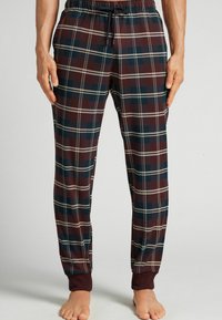 Kárované volné kalhoty v odstínech vínové, námořnické modři a krémové barvě, s elastickým pasem, stahovací šňůrkou a ribbed manžetami.