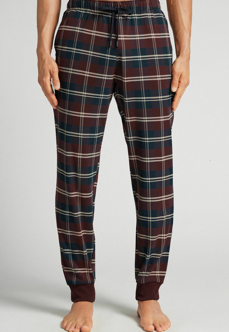Geruite loungebroek met een maroon, marineblauw en crème kleurenschema, elastische tailleband, trekkoord en ribgebreide boorden.