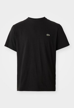 T-shirt noir à manches courtes avec col rond et petit logo crocodile vert Lacoste sur le côté gauche de la poitrine.