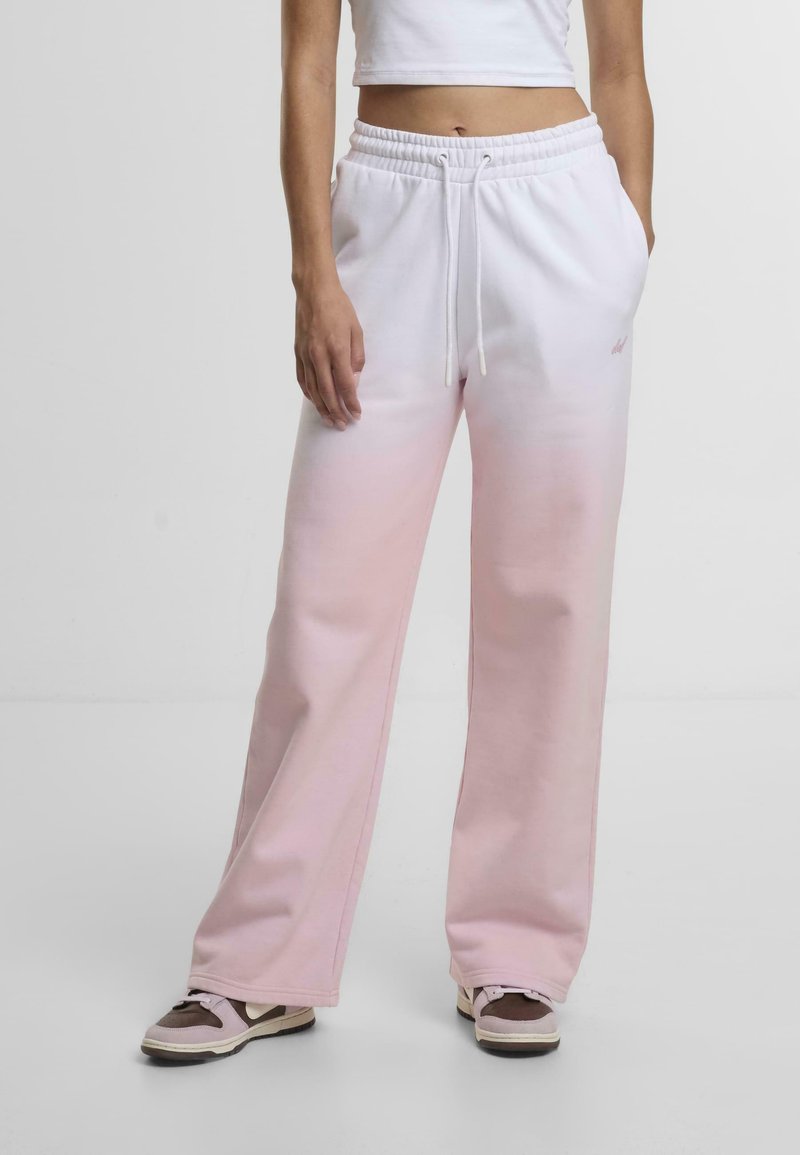 Sweatpants in gradient pink and white, made of soft fabric. Features a drawstring waist, side pockets, and a loose fit with a slight flare.