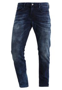 Vaqueros de mezclilla azul oscuro con corte recto, detalles deslavados, diseño de cinco bolsillos y cierre de cremallera con botón.