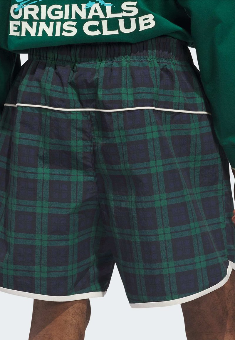 Grün-kariert und marineblaue Badehose mit elastischem Bund, weißen Paspeln und entspannter Passform, gefertigt aus einem leichten, strukturierten Stoff.