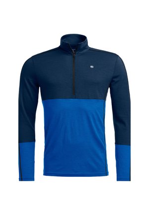 Men's half-zip long sleeve top in dark blue and bright blue, made of soft fabric with contrasting sections and black zip detail.