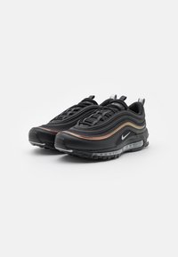 Black Nike Air Max 97 sneakers with textured leather, mesh, and rubber. Features a prominent air bubble, silver accents, and multicolor stripe detailing.