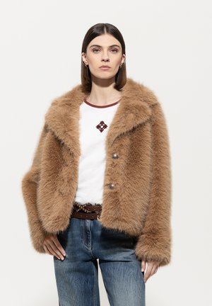 Brown faux fur jacket with wide lapels, two front buttons, and a cropped cut. Worn over a white shirt with a burgundy neckline and accent.