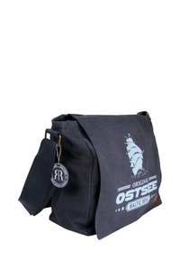 Navy canvas shoulder bag with adjustable strap, featuring a light blue ship graphic and “Original Ostsee Baltic Sea” text, finished with a logo tag.
