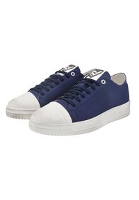 Navy canvas sneakers with white rubber toe cap and sole. Features flat laces and eyelets. Clean design and textured fabric.