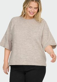 Maglione beige lavorato a maglia con scollo rotondo, maniche corte e vestibilità comoda. Tessuto morbido con un motivo sottile e orlo dritto.
