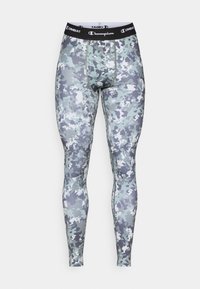 Álcázó sportleggings szürke és fehér árnyalatokban, fekete derékrésszel, amelyen a "Champion" márka látható, és testhezálló kialakítással.