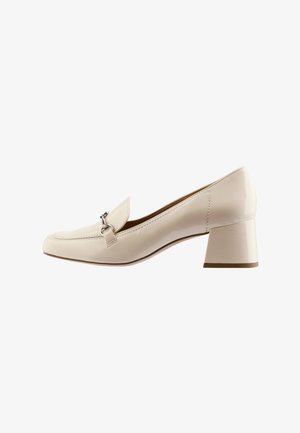 Beige patent leather loafer with a low block heel, rounded toe, and a decorative loop accent on the front. Smooth, glossy finish.
