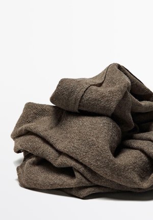 Brown folded woolen sweater with visible knit texture on a white background.