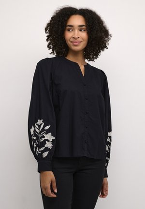 Navy button-up blouse with a V-neck, featuring embroidered floral designs on the sleeves. Soft fabric with puffed long sleeves.