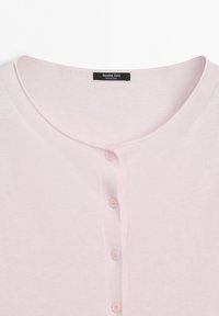 Light pink cardigan with round neckline and four small matching buttons down the front, labeled Massimo Dutti, made in China.