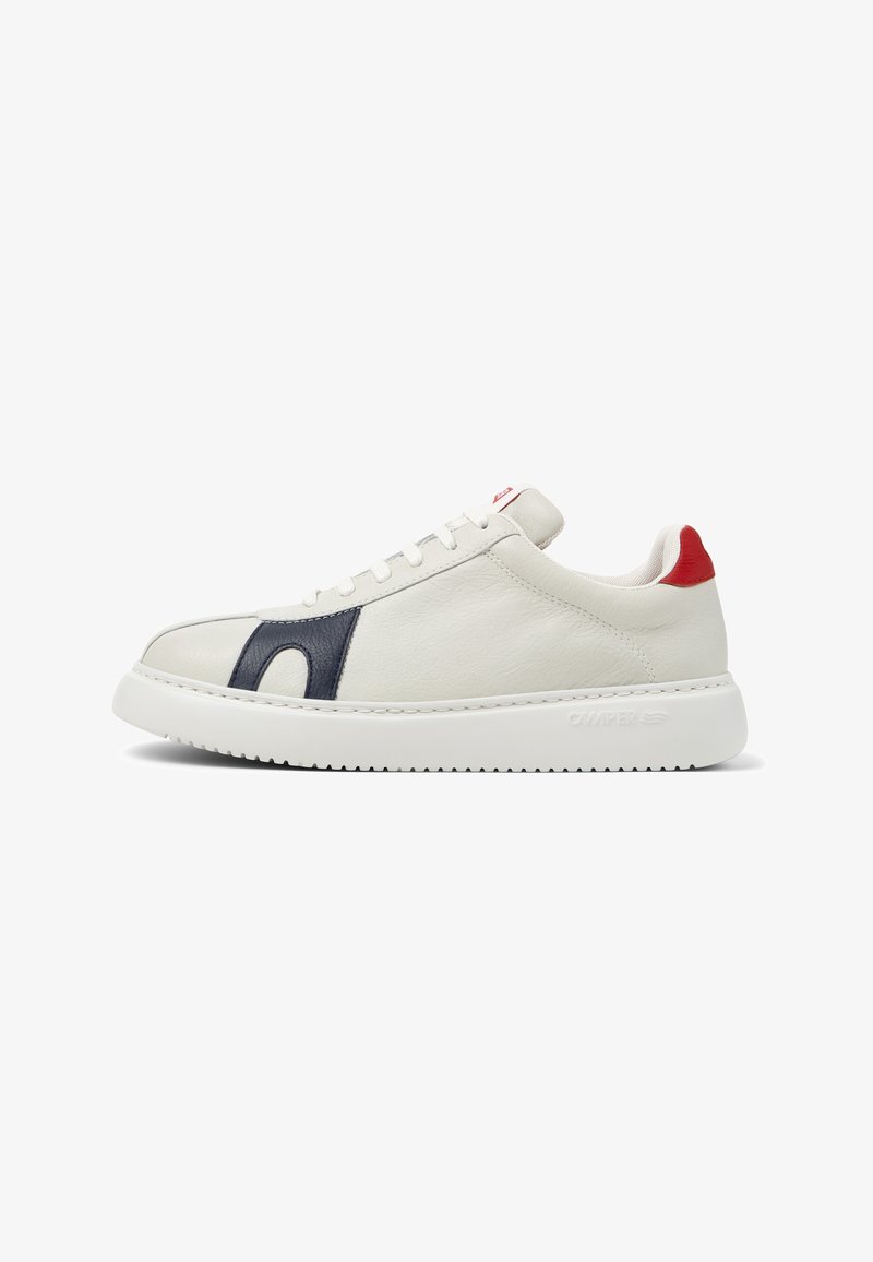 White leather sneaker with navy side detail, red heel tab, white laces, and thick white sole branded "Camper" on the side.