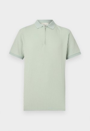 Világoszöld bordázott rövid ujjú galléros póló cipzáras gombolattal, texturált gallérral és ujjmandzsettával.