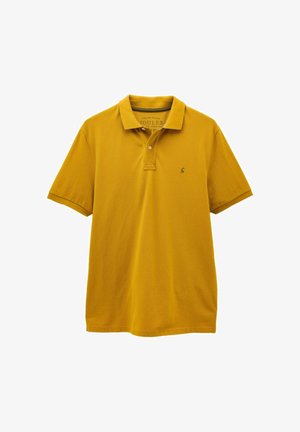 Lühikeste varrukatega sinepikollane polo-särk, millel on krae, kaks nööpaukku ja väike tikitud logo vasakul rinnal.