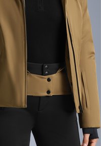 Brown jacket with a zip closure, featuring a black belt at the waist secured with black buttons, paired with black pants.