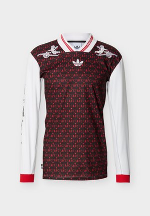 Pikkade varrukatega musta ja punast AFC mustriga särk valgete varrukatega, punaste mansettide, valge krae punaste triipudega, Adidas logo ja tiivuliste rattamotiividega.