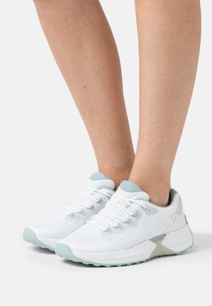 White athletic shoes with a breathable mesh upper, light blue accents, and a thick sole featuring textured patterns for traction.