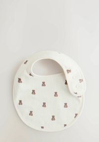 Cotton bib with a rounded shape, white ribbed texture, and a repeating teddy bear print in brown. Two snap closures for adjustment.