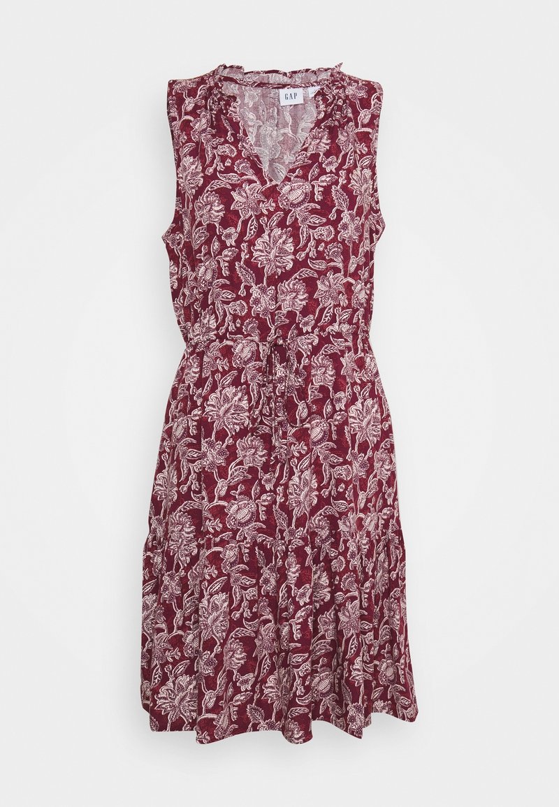 Robe sans manches longueur genou avec fond bordeaux et motif floral blanc, col en V et taille à cordon.