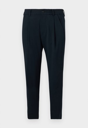 Navyblauwe taps toelopende broek met zijzakken, knoopsluiting en elastische tailleband aan de achterkant.