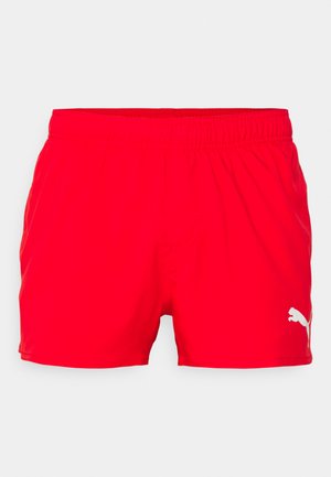 Red athletic shorts with an elastic waistband, featuring a white Puma logo on the lower left side. Smooth texture and lightweight fabric.