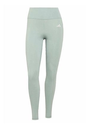 Leggings de talle alto verde claro con un pequeño logo blanco de Adidas en la parte superior del muslo derecho, mostrados sobre un fondo blanco.