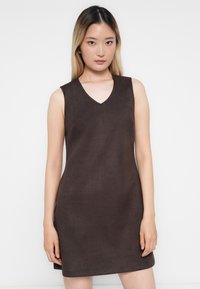 Brown sleeveless dress in a soft, suede-like material, featuring a V-shaped neckline and a fitted design that tapers slightly at the waist.
