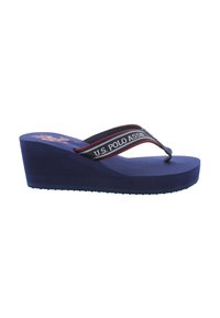 Blå kilflip-flop med en strukturerad sula. Har ett svart och rött band med "U.S. POLO ASSN." tryckt. Enhetlig design, avslappnad stil.