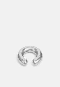 Silver metal accessory featuring a rounded, open design with a smooth finish and a seamless curve. Engraved brand name on one side.