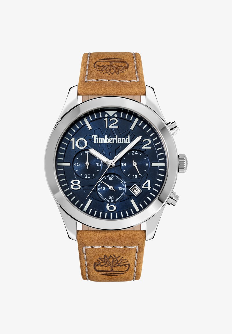 Orologio in acciaio inossidabile argentato con quadrante blu scuro, numeri bianchi e cinturino in pelle marrone chiaro con logo impresso.