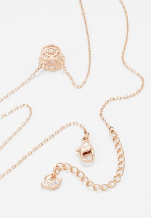 Delicate rose gold chain necklace with circular slider, lobster clasp, and small swan charm adorned with clear crystals.