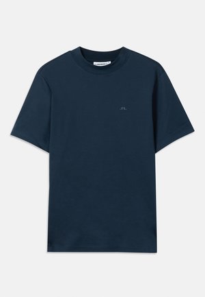 T-shirt en coton bleu marine avec un col rond, des manches courtes et un logo discret imprimé sur la poitrine. Texture lisse et coupe classique.