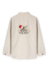 Beige overhemd met lange mouwen featuring een geborduurd grafisch ontwerp met een cowboy op een paard, bergen en een rode zon. Knopenmanchetten.