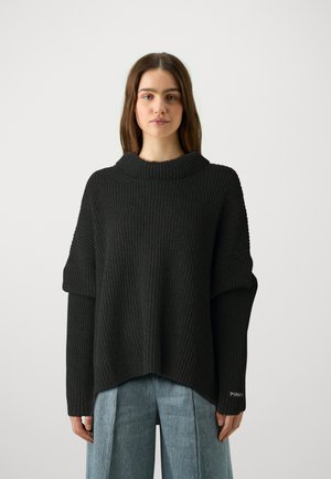 Black ribbed knit sweater with a high collar, dropped shoulders, and a loose fit, featuring a label with "PINKO" on the left sleeve.