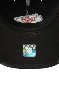 Black cap with a Kansas City Chiefs logo on the inside and an NFL holographic authenticity sticker under the brim.