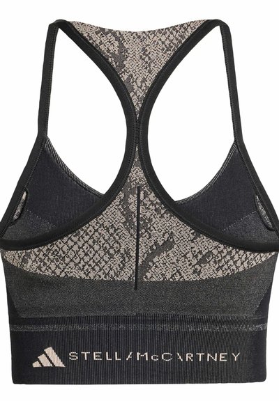Black athletic bra with a racerback design, featuring a textured snakeskin pattern in shades of beige on the upper section and a logo band.