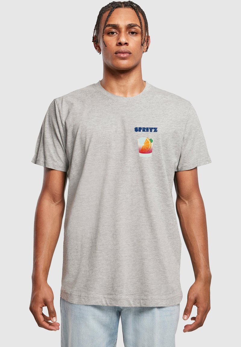 Szürke pamut kereknyakú póló, amelyen egy ital grafikája látható narancs szelettel és a „SPRITZ” felirattal kék színben. Rövid ujjú, laza fit.